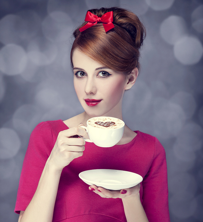 Redhead girl with coffee cup. St. Valentine Day.